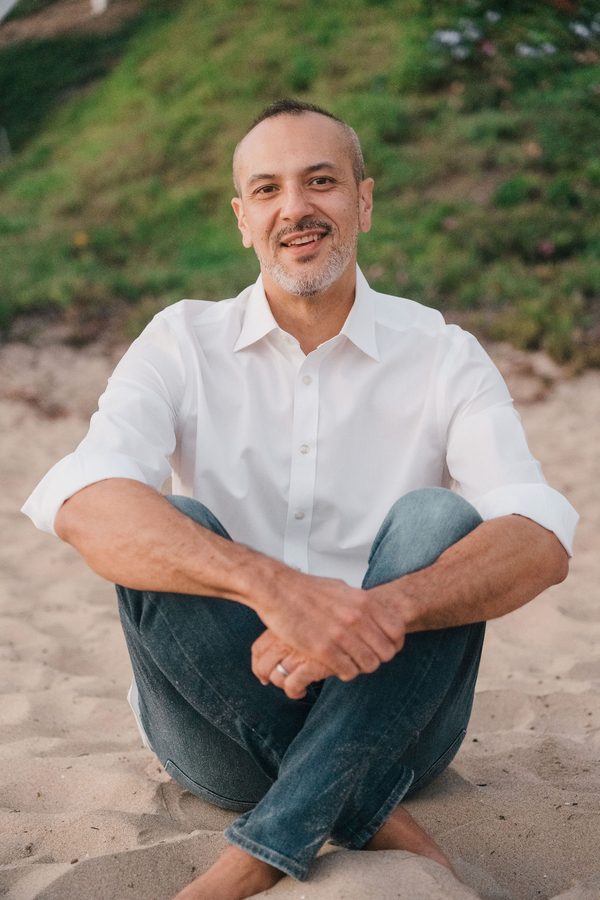 Andrew Flynn, AMFT, seated outdoors.